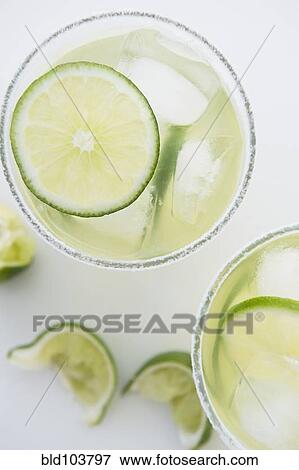 Stock Photo - Limes in margaritas. Fotosearch
