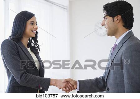 Stock Photo - Mixed race business people shaking hands. Fotosearch
