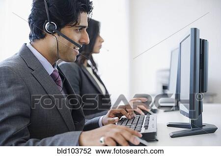 Mixed race business people using computers View Large Photo Image Stock Image - Mixed race business people using computers. Fotosearch