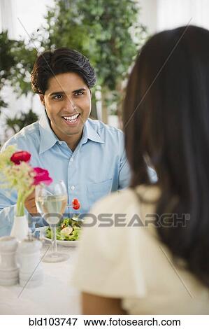 Stock Photo - Mixed race couple dining together. Fotosearch