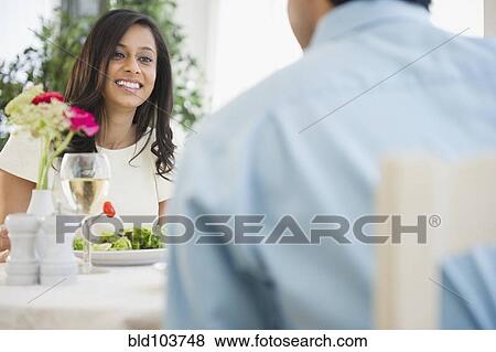 Stock Photo - Mixed race couple dining together. Fotosearch