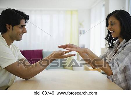 Mixed race couple playing slapping game View Large Photo Image Stock Photograph - Mixed race couple playing slapping game. Fotosearch
