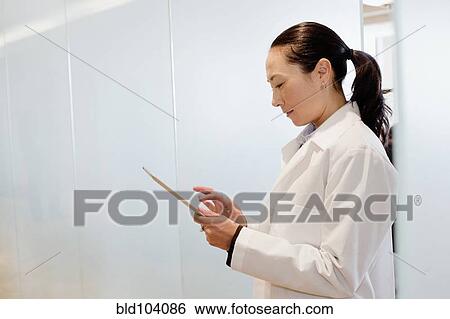 Mixed race doctor using digital tablet View Large Photo Image Stock Photograph - Mixed race doctor using digital tablet. Fotosearch