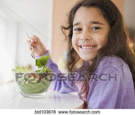 Mixed race girl eating salad View Large Photo Image Stock Photo - Mixed race girl eating salad. Fotosearch