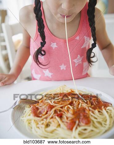 Mixed race girl eating spaghetti View Large Photo Image Stock Photo - Mixed race girl eating spaghetti. Fotosearch