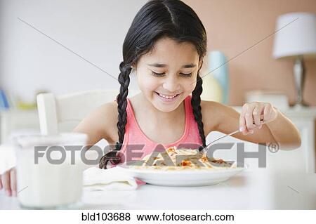 Mixed race girl eating spaghetti View Large Photo Image Stock Photo - Mixed race girl eating spaghetti. Fotosearch