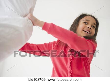 Stock Photo - Mixed race girl holding pillow. Fotosearch