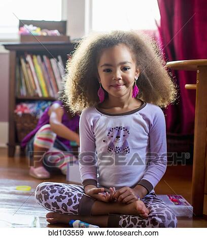 Mixed race girl in pajamas and feather earrings View Large Photo Image Stock Photo - Mixed race girl in pajamas and feather earrings. Fotosearch