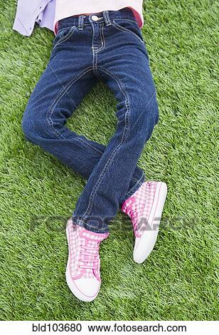 Mixed race girl laying on grass View Large Photo Image Stock Image - Mixed race girl laying on grass. Fotosearch