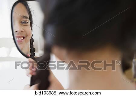 Mixed race girl looking in mirror View Large Photo Image Stock Photography - Mixed race girl looking in mirror. Fotosearch