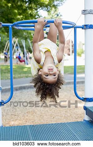 Mixed race girl playing on playground View Large Photo Image Stock Image - Mixed race girl playing on playground. Fotosearch