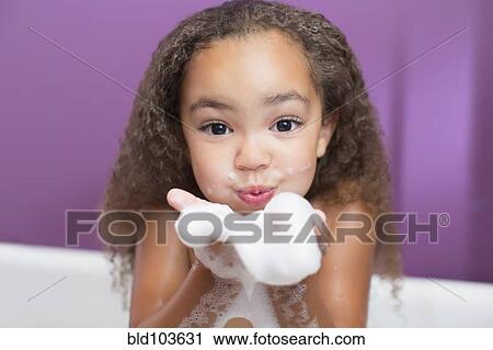 Mixed race girl playing with bubbles in bathtub View Large Photo Image Stock Image - Mixed race girl playing with bubbles in bathtub. Fotosearch