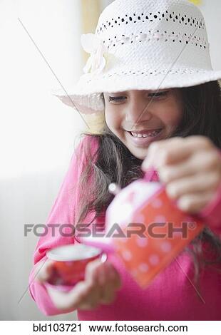 Mixed race girl pouring tea View Large Photo Image Stock Image - Mixed race girl pouring tea. Fotosearch