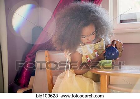 Mixed race girl pouring tea View Large Photo Image Stock Photo - Mixed race girl pouring tea. Fotosearch