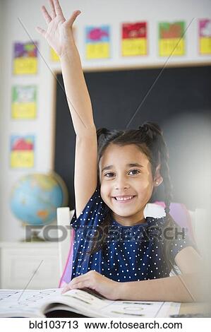 Mixed race girl raising her hand in classroom View Large Photo Image Stock Image - Mixed race girl raising her hand in classroom. Fotosearch
