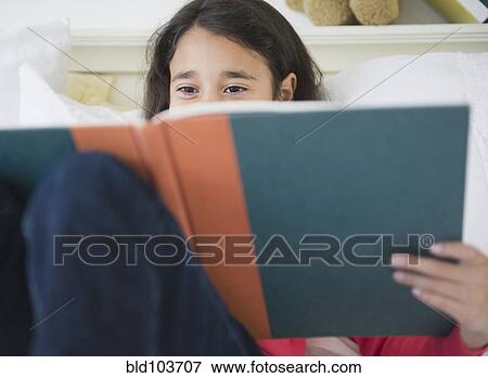 Mixed race girl reading a book View Large Photo Image Stock Photo - Mixed race girl reading a book. Fotosearch