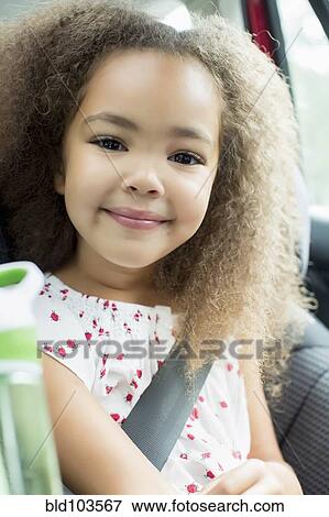 Stock Photo - Mixed race girl sitting in car seat. Fotosearch