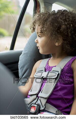 Stock Photography - Mixed race girl sitting in car seat. Fotosearch