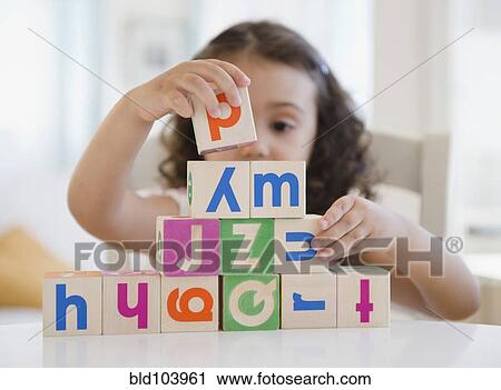 Mixed race girl stacking blocks View Large Photo Image Stock Image - Mixed race girl stacking blocks. Fotosearch
