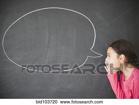 Stock Image - Mixed race girl standing by speech bubble on blackboard. Fotosearch
