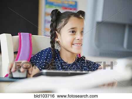 Mixed race girl using computer View Large Photo Image Stock Photograph - Mixed race girl using computer. Fotosearch