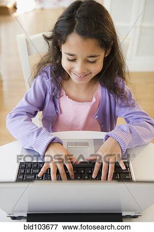 Mixed race girl using laptop View Large Photo Image Stock Photo - Mixed race girl using laptop. Fotosearch