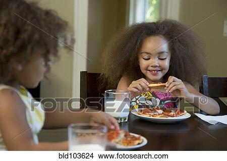 Mixed race girls eating pizza View Large Photo Image Picture - Mixed race girls eating pizza. Fotosearch