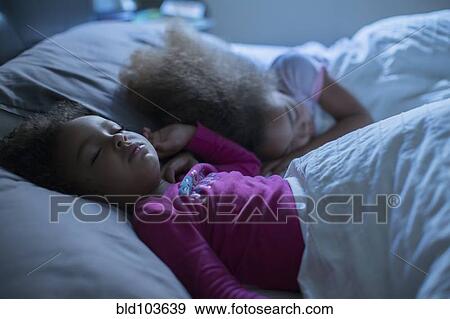 Mixed race girls sleeping in bed View Large Photo Image Stock Photo - Mixed race girls sleeping in bed. Fotosearch