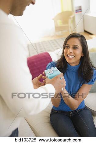 Mixed race man giving girlfriend a gift View Large Photo Image Stock Photography - Mixed race man giving girlfriend a gift. Fotosearch