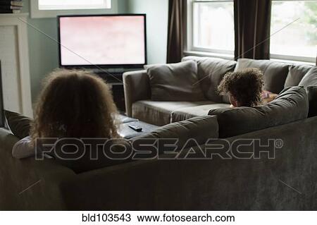 Mother and daughter watching television View Large Photo Image Stock Image - Mother and daughter watching television. Fotosearch