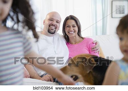 Mother and father watching children and dog View Large Photo Image Picture - Mother and father watching children and dog. Fotosearch