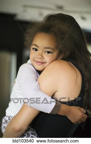 Mother carrying daughter View Large Photo Image Stock Image - Mother carrying daughter. Fotosearch