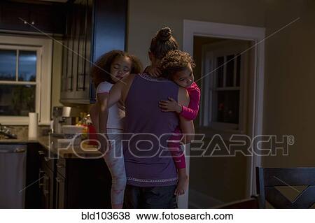 Mother carrying sleeping daughters View Large Photo Image Stock Photo - Mother carrying sleeping daughters. Fotosearch