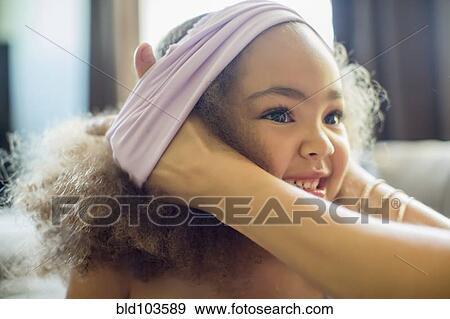 Stock Photo - Mother dressing daughter. Fotosearch
