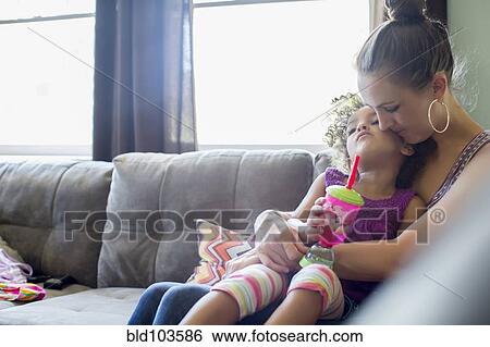 Stock Photograph - Mother holding daughter on lap. Fotosearch