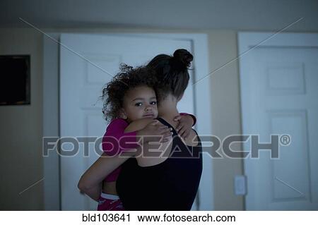 Stock Image - Mother holding daughter. Fotosearch