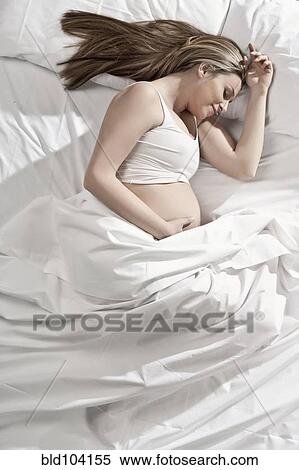 Pregnant woman sleeping in bed View Large Photo Image Stock Photography - Pregnant woman sleeping in bed. Fotosearch