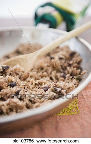 Stock Photograph - Rice and beans cooking in skillet. Fotosearch