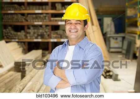 Stock Photograph - Smiling Hispanic carpenter. Fotosearch