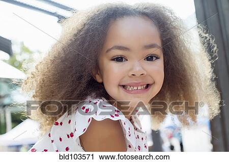 Stock Image - Smiling mixed race girl. Fotosearch