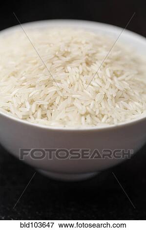 Uncooked rice in bowl View Large Photo Image Stock Photo - Uncooked rice in bowl. Fotosearch