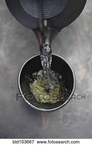 Water being poured on tea leaves View Large Photo Image Stock Photo - Water being poured on tea leaves. Fotosearch
