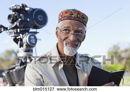 Stock Photo - African American director near film camera. Fotosearch