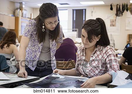 Art teacher reviewing student's artwork View Large Photo Image Stock Image - Art teacher reviewing student's artwork. Fotosearch