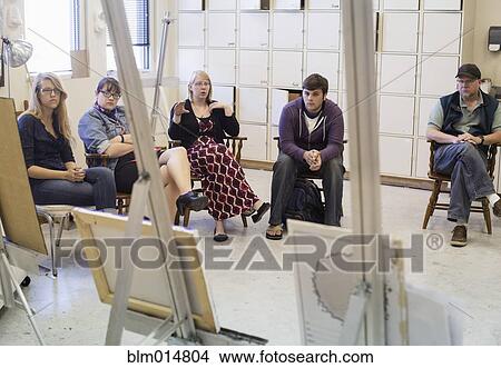 Picture - Artists critiquing work in studio. Fotosearch