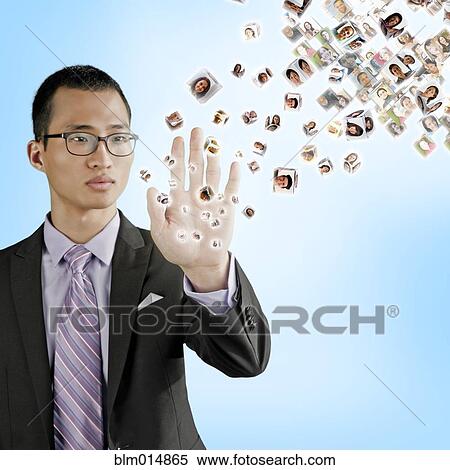 Asian businessman holding hand out to digital images View Large Photo Image Stock Photography - Asian businessman holding hand out to digital images. Fotosearch