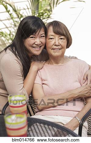 Asian mother and daughter hugging View Large Photo Image Stock Photograph - Asian mother and daughter hugging. Fotosearch