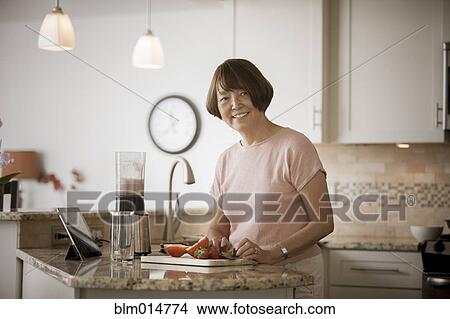 Asian woman preparing food View Large Photo Image Picture - Asian woman preparing food. Fotosearch
