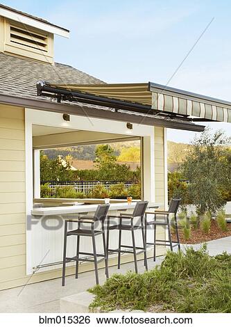 Stock Photograph - Bar and bar stools on patio. Fotosearch