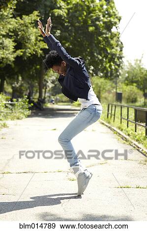 Black woman balancing on toes in park View Large Photo Image Stock Photo - Black woman balancing on toes in park. Fotosearch